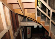 Temporary, 2x4 guardrails, screwed together for easy removal, provide fall protection for workers using the rough stair.