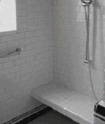 Installed after the rest of the shower had been completed, this tiled bench is supported by a lightweight aluminum frame; it required neither extra framing nor a waterproofing membrane.