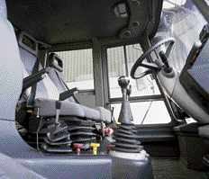 Despite a drab exterior color scheme, the HMEE's interior is quite plush. Joystick controls and cloth air-ride seats with adjustable armrests ease the fatigue of long hours spent loading and digging.