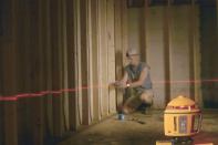 Going straight: Laser level lines take the guesswork out of where to drill for wire, pipe, and tubing--all of which go in easier through a straight run of holes.
