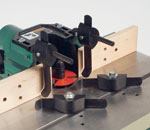 Bridgewood's hold-downs are simple and work well. The       shaper has the only table tapped for hold-downs that guide the work along       the fence.