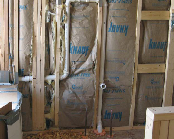 Batt insulation works best when it is fully lofted, not jammed into the tight spaces. Compression of the batt reduces the number of air pockets that provide the material's insulation value. It also leaves a hollow between the insulation and the drywall, creating areas where air can circulate. These voids can siphon off energy and may create conditions for condensation and moisture problems.