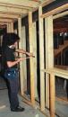Parallel 2x4 partition walls provide acoustic separation between rooms. To reduce sound transmission to the living space above, the author dropped separate 2x10 ceiling joists below the plane of the I-joist floor system.