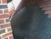 To make room for the cricket, the author strips the roofing around the chimney.