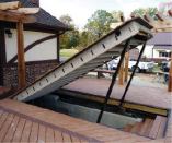 Figure 1. Powered by a 12-volt winch, this steel-framed hatch blends flush with the decking, but can be opened with the flick of a switch to provide basement access.