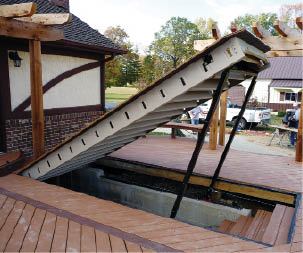 Figure 1. Powered by a 12-volt winch, this steel-framed hatch blends flush with the decking, but can be opened with the flick of a switch to provide basement access.