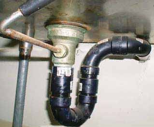 The drain connection at the wall is too high on this sink, resulting in a 9-inch-deep trap seal — 5 inches deeper than is allowed by code.
