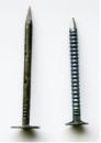 Both the cement-coated smooth-shank drywall nail (far left) and the blued ring-shank drywall nail (left) meet code requirements, but they’re more likely to pop than a drywall screw.