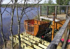 The four-passenger car on this elevator overlooking Ontario's Muldrew Lake has been custom-finished with red cedar siding. To prevent it from blocking the view from the deck, a programmable controller sends it out of sight down the slope 15 minutes after it comes to a stop at the top station. Entering a use code on the post-mounted control panel (at right in photo) calls it back for another trip.