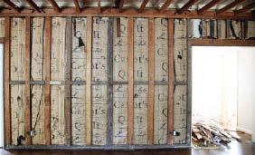 The Cabot's Quilt insulation behind the partition wall of this California home is rich in history, though it's of limited value as an insulator.