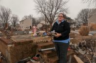 Union Beach, NJ, Dec 17,2012--Jennette Van Houton, a resident of Union Beach holds some of her neigbhbors' possessions that survived Hurricane Sandy's wrath. Van Houton's own house was destroyed when flood waters came through her neighborhood. Photo by Patsy Lynch/FEMA