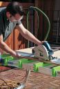 Having positioned the stock with the cut line over the recessed part of the crossbars, the author rips it without fear of cutting into the surface below. The recesses can also be used as stops when cross-cutting narrow material with a hand-held saw.