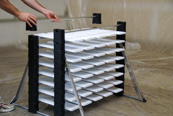 You assemble the Erecta-Rack as you go; when one level is filled, you put another set of bars on top so there will be room for another layer of material.