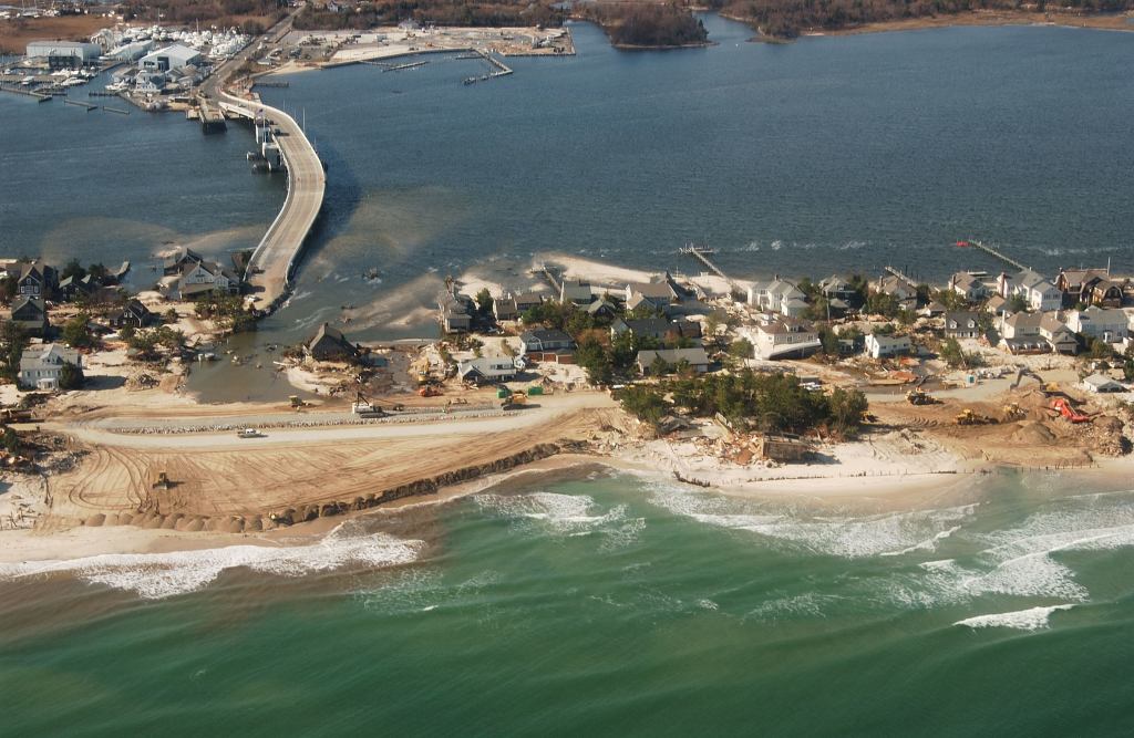 Ed Wright’s house sits at the center of this NOAA aerial photo surrounded by water and sand, where crews are rebuilding the washed-away portions of the barrier island breached by Hurricane Sandy in Mantaloking. Wright’s house, elevated on pilings, survived virtually intact while neighboring homes were completely destroyed.
