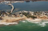Ed Wright’s house sits at the center of this NOAA aerial photo surrounded by water and sand, where crews are rebuilding the washed-away portions of the barrier island breached by Hurricane Sandy in Mantaloking. Wright’s house, elevated on pilings, survived virtually intact while neighboring homes were completely destroyed.