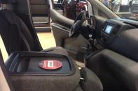 Taken at the 2013 Remodeling Show, an interior shot of the 2014 Nissan NV3500 shows how the fold-flat front passenger's seat can serve as a work table.