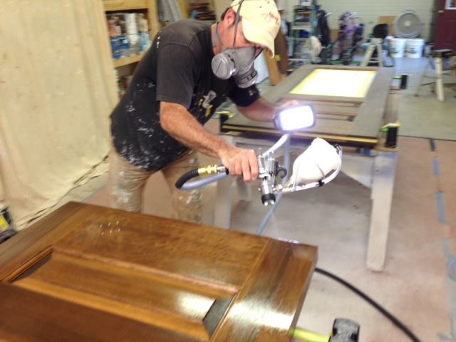 Todd applies clear finish on gel stained custom fir doors.