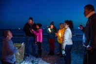 Residents gather at the shore in Rockaway Beach, New York, on the one-year anniversary of Hurricane Sandy's landfall.