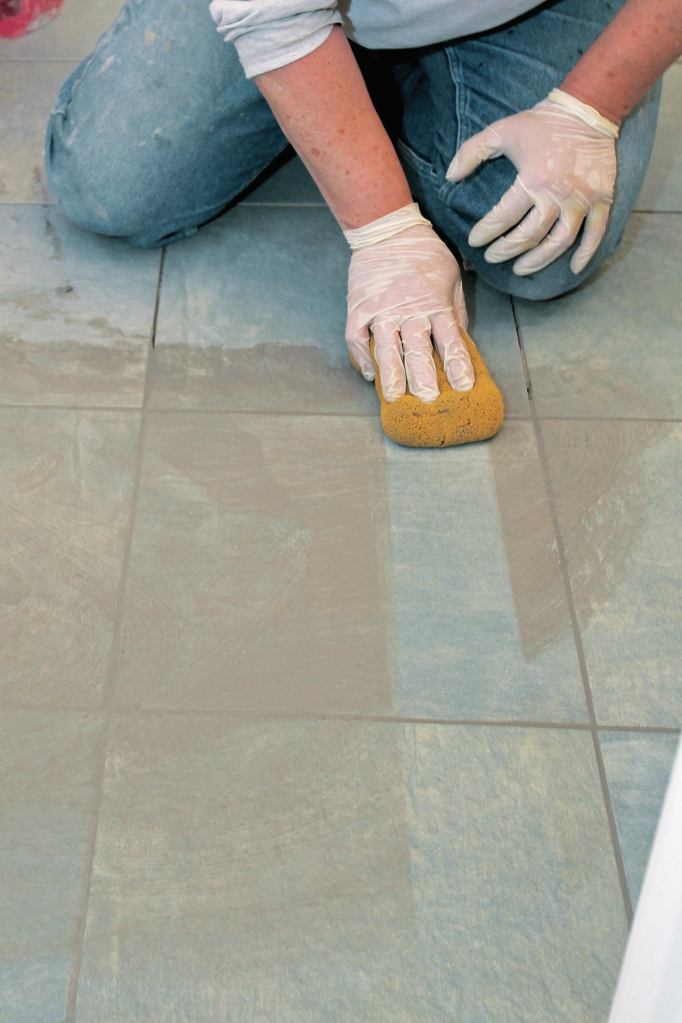 After scrubbing the tile, wipe with a clean sponge, making one pass per side of the sponge before rinsing.