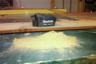 The dust-collection bag, though not highly efficient, does collect most of the dust. This pile of dust, which I dumped onto the bench after 10 to 15 minutes of sanding, filled the collection bag about halfway.