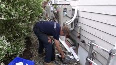 Master plumber Dave Ragsdale purges the refrigerant lines of a 12,000-Btu Fujitsu mini-split heat pump. In tandem, the solar panels and heat pumps will relieve the home's existing oil boiler of much of its annual job.
