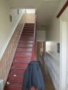 As is typical in townhomes of its vintage, the Brooklyn project house has a staircase that hugs one of the long party walls between units, and a "relieving wall" that helps support the floor joists, which run across the whole width of the unit. This wall was removed during renovations, requiring the floor system to be reinforced.