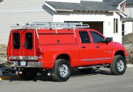 The truck is 2006 Dodge 2500 with a rack and a custom cap.