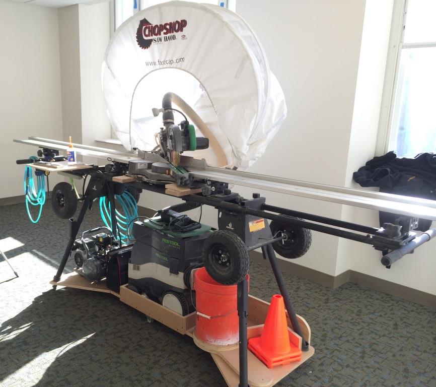 The mobile base carries a miter saw stand and multiple tools—including a compressor and dust extractor. The stand is a BestFence Pro 3 and the dust hood is a prototype of a new ChopShop hood. Both tools are from FastCap. On the stand is an 8 1/2-inch Hitachi slide miter saw.