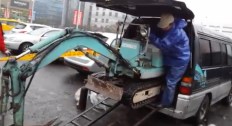 mini excavator being loaded into a minivan
