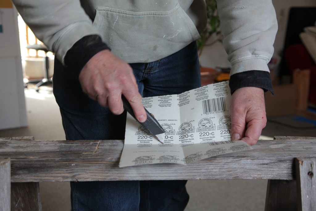 Cut one of the four folds from the center out to the edge. It does not make a difference which fold you cut.