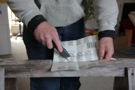 Cut one of the four folds from the center out to the edge. It does not make a difference which fold you cut.