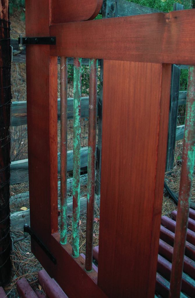 Prior to assembly, the copper balusters used in this garden gate (standard 3/4-inch-diameter Type-M copper tubing) were placed for about a week in a wooden crate containing sawdust soaked with a solution of muriatic acid and salt mixed with water.