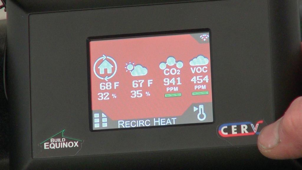 A close-up of the remote-control display for the Build Equinox shows readouts for temperature, humidity, carbon dioxide, and volatile organic compounds. The CERV's "black box" sensor and control system continously monitors CO2 levels, VOC levels, and temperature in the occupied rooms, and implements air exchange as needed to keep air quality within parameters selected by the occupant.