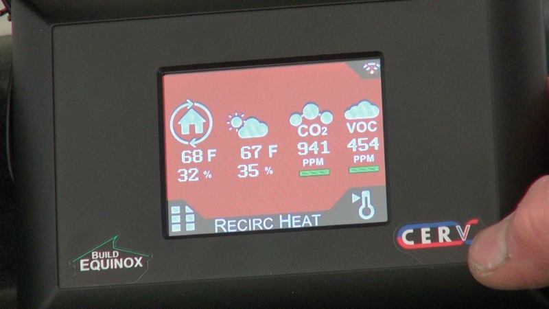 A close-up of the remote-control display for the Build Equinox shows readouts for temperature, humidity, carbon dioxide, and volatile organic compounds. The CERV's "black box" sensor and control system continously monitors CO2 levels, VOC levels, and temperature in the occupied rooms, and implements air exchange as needed to keep air quality within parameters selected by the occupant.