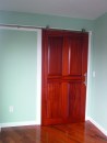 Using portable power tools on a simple jobsite setup, it’s possible to make a custom door slab. The trick is creating a strong joint between the stiles and rails, which is done here with a Festool Domino. The author built this sliding passage door out of Utile, an African ribbon-stripe mahogany.