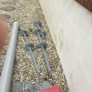 Helical piers are like giant screws that are driven into the ground to a specified depth to achieve the proper bearing capacity. Helical piers come in 4-ft. sections that make it easier to drive them in more compact spaces.