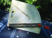 A homemade pitch-measuring tool determines the pitch of an existing shed roof.