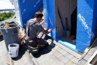 Mark Pollard applies self-adhering, vapor-open Henry Blueskin to the sheathing of a dormer on Peaks Island, Maine. (Photo by Ted Cushman)