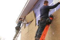 The Caleb Contracting crew rebuilds and upgrades a house wall using vapor-open, fire-resistant Gold Bond  eXP Sheathing from National Gypsum, and ComfortBoard 80 rigid mineral wool insulation from Roxul.