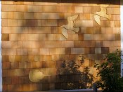 A horseshoe crab and two soaring shore birds grace the back wall of a cottage on Cape Cod.