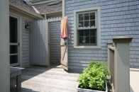Many Cape Codders use their outdoor showers for more than just places to wash the beach sand from their feet. These little outdoor gems become their principle showering spots during all but the coldest months of the year. In the spirit of the nearby ocean, this outdoor shower sports wave shapes carved into the enclosure boards.
