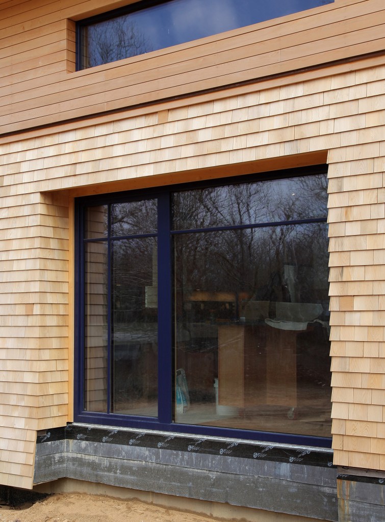 Different wall strategies required different exterior casing strategies for the upper and lower walls on this passive house. Photo by Roe Osborn