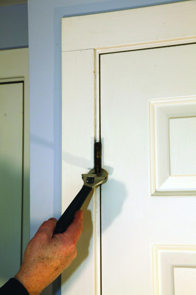 There are two ways to adjust the gap between the slab and the hinge jamb on a prehung door. The quick way is bending the hinge barrels over with an adjustable wrench.