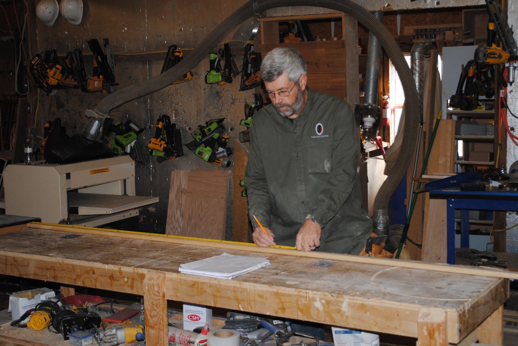 A story pole creates a full-scale layout for building the doors. Measurements are for the stiles and rails in the  adjacent panels as well as for the width of the opening.