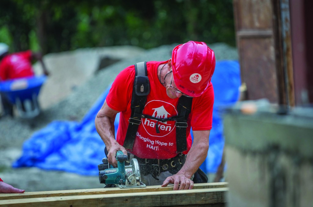 As part of a volunteer group, the author helps rebuild a school in Haiti.