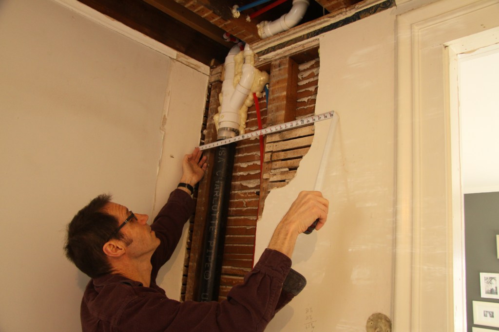 A drain pipe that had been relocated into the wall cavity couldn’t be pushed back far enough and stuck out beyond the plane of the existing plaster surface.