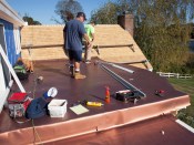 Matt Quigley and Roger McCool of J Bennette Roofing, Inc. install a new, copper-colored European-made 60-mil, polyester-reinforced PVC membrane by Sentinel Copper Art (soprema.us) in the coastal town of Cohasset, MA.