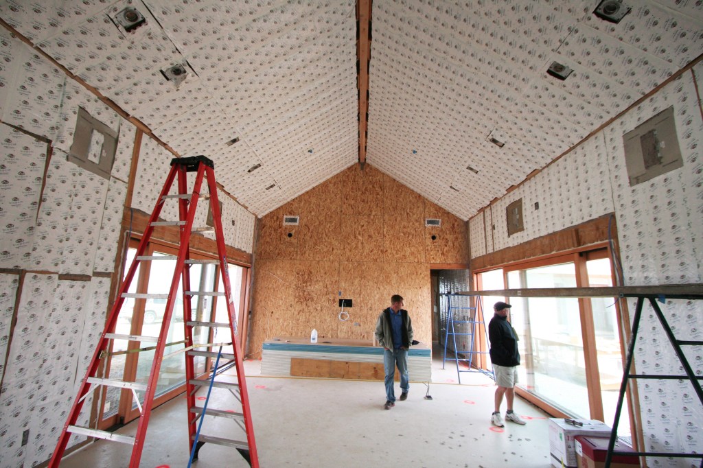 BioPCM phase change material installed behind drywall will shave energy costs while maintaining comfort in this California showcase home, stabilizing the room temperature by melting or solidifying to absorb or release heat whenever temperatures are warmer or cooler than the melting point of the material. (Photo by Alliance Green Builders)