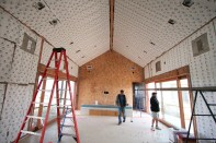 BioPCM phase change material installed behind drywall will shave energy costs while maintaining comfort in this California showcase home, stabilizing the room temperature by melting or solidifying to absorb or release heat whenever temperatures are warmer or cooler than the melting point of the material. (Photo by Alliance Green Builders)