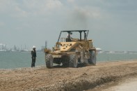 Texas City, Texas, May 17,2010 --Construction crews work on rebuilding the road on the Texas City dike.  FEMA is providing 90% of the estimated $5.2 million dollars needed to repair the 5 mile-long fishing pier, which is the longest man-made pier of its kind.  The pier was damaged when Hurricane Ike hit the area.  Photo by Patsy Lynch/FEMA